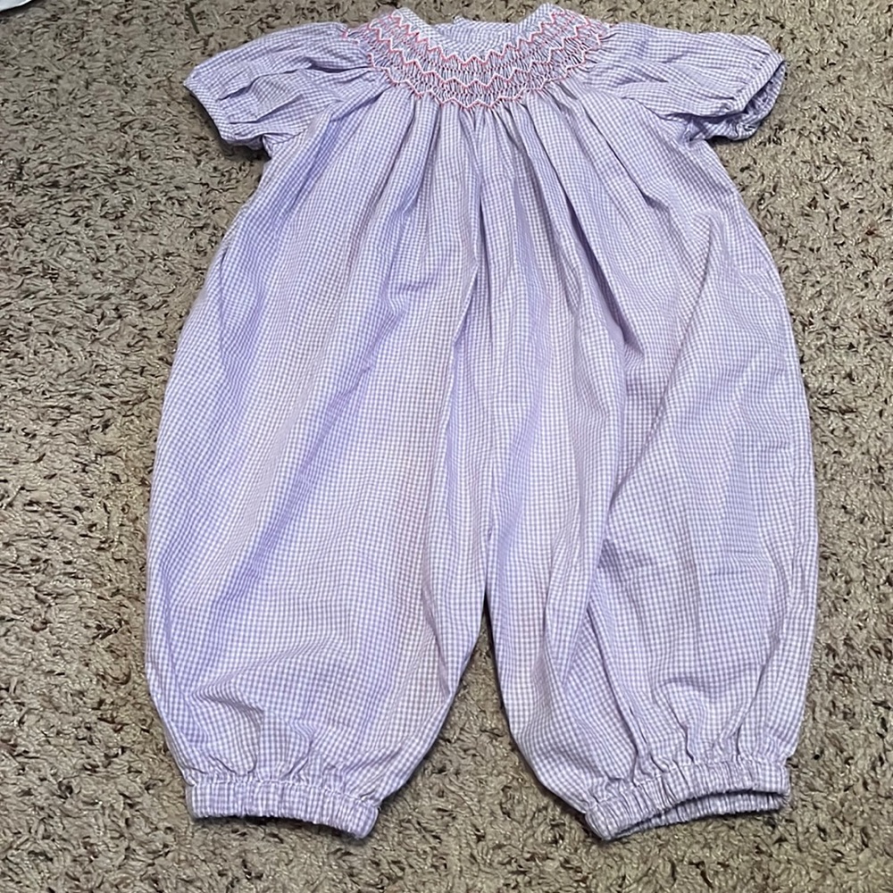 Smocked Lavender Romper with pink and white smocked detail.